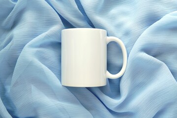 White ceramic mug mockup for design presentation, feminine composition on light blue scarf.