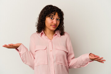 Young mixed race woman isolated on white background doubting and shrugging shoulders in questioning gesture.