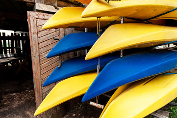 plastic boats for river trips on a rack