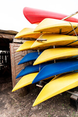 plastic boats for river trips on a rack