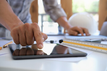 Architect or engineer working in office with blueprints,engineer inspection in workplace for architectural plan,sketching a construction project ,selective focus,Business construction concept.