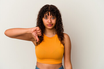 Young mixed race woman isolated on white background showing thumb down, disappointment concept.