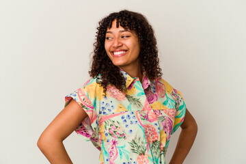 Young mixed race woman isolated on white background laughs happily and has fun keeping hands on...