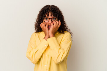 Young mixed race woman isolated on white background biting fingernails, nervous and very anxious.