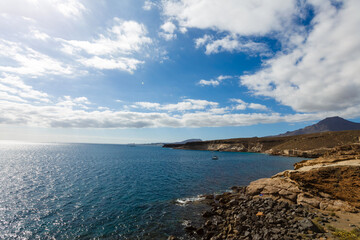 The waves breaking on a stony beach, ocean shore with stones