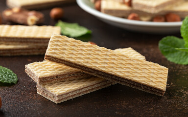 Tasty wafer biscuits with chocolate on rustic table - obrazy, fototapety, plakaty