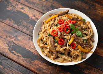 Stir fry Beef Chow Fun with rice noodles, bean sprouts, spring onions and chili.