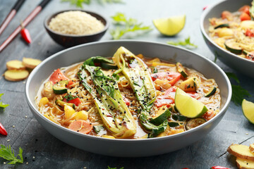 Asian style Pak choi, lemongrass, and ginger curried noodles served with lime wedges