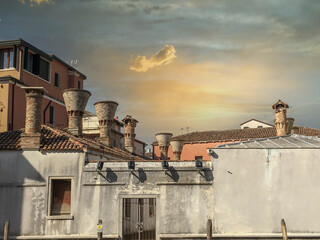 venice roofs with an old house in front at summer