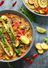 Asian style Pak choi, lemongrass, and ginger curried noodles served with lime wedges