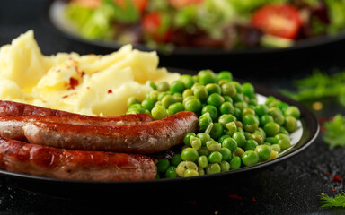 Pork Chipolata sausages with home cooked mashed potato and green peas