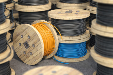 Wire electric cable on wooden coil or spool isolated on warehouse.