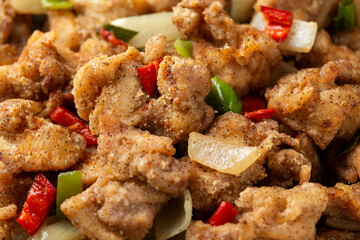 Stir fry chinese salt and pepper chicken with rice in grey bowl