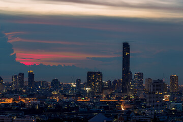 The high angle background of the city view with the secret light of the evening, blurring of night lights, showing the distribution of condominiums, dense homes in the capital community