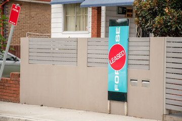 For lease and leased sign on a display outside of a residential building