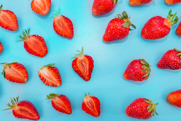 Many sweet ripe strawberries on blue.