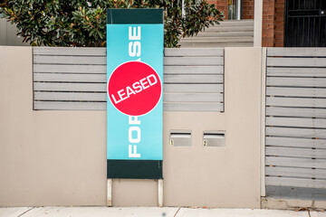 For lease and leased sign on a display outside of a residential building - obrazy, fototapety, plakaty