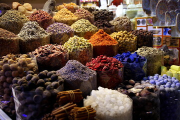 A stall in the Old Souk with piles of colorful spices (indigo, saffron, turmeric, lavender, walnuts, chilli), Dubai, UAE