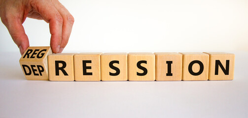 Depression or regression symbol. Doctor turns cubes and changes the word 'depression' to 'regression'. Beautiful white background. Psychological, depression or regression concept. Copy space.