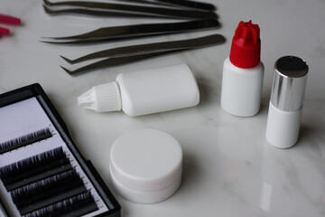 Lashmaker tools on white light background
