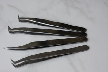 Lashmaker tools on white light background