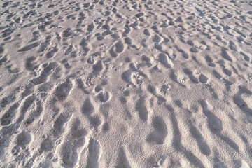 Detail texture of white sand Sea sun beach for relax in holiday Sunny summer background with foot print on sand beautiful beach in phuket thailand
