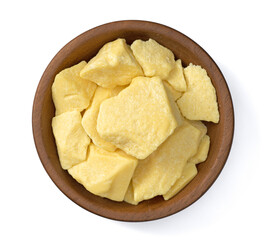 raw cocoa butters in the wooden plate, isolated on white background, top view