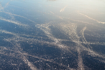 Ice on the river with skate tracks in winter outdoor