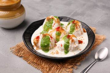 Indian street food Dahi vada Dahi Bhalla with green chutney, tamarind chutney chaat appetizer thayir vadai curd vada soaked in yogurt. North Indian snack Delhi Mumbai India, sri Lanka ,Pakistani food