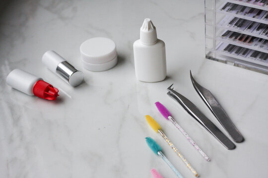 Lashmaker tools on white light background