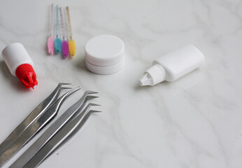 Lashmaker tools on white light background