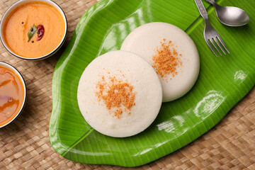 Thatte idli or Plate idly with sambar coconut chutney, chutney podi popular breakfast of Kerala...