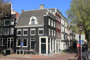 Amsterdam Canal Street View with Traditional Architecture and Blue Sky