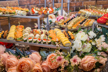 Buffet table with food and snacks for the guests of the event. Service at business meetings, weddings. Full table of appetizers