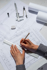 Naklejka na ściany i meble Architect designer draws a sketch of the project on white paper. Engineering blueprints.