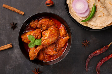 Spicy red chicken curry. Goan style chicken vindaloo. Butter chicken Murgh Makhani curry roast hot and spicy gravy dish Dhaba Punjab, India. North Indian non-vegetarian cuisine Garam Masala. tikka