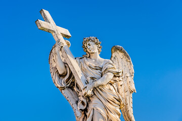 Obraz premium Medieval outdoor statue of an Angel with the Cross by Ercole Ferrata on Sant'Angelo Bridge in Rome, Lazio region, Italy