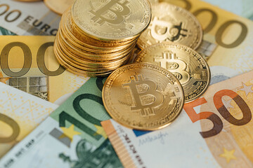 Euro Banknotes and Bitcoin cryptocurrency investing concept. Euro Money and Crypto currency golden bitcoin coin.