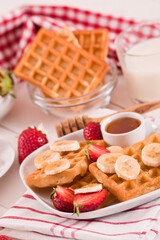 Waffles with strawberries, bananas and honey.