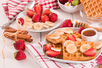 Waffles with strawberries, bananas and honey.