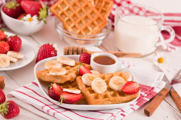 Waffles with strawberries, bananas and honey.