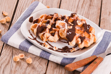 Waffles with chocolate cream and hazelnuts.