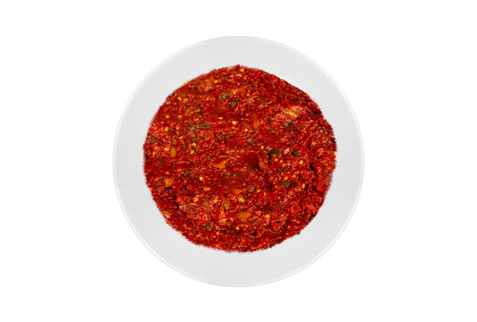 Traditional appetizer dishes "Acili Ezme" on a dinner plate. Top view