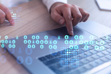Hands of hr specialist is typing the keyboard in the internet to find the best candidates to create international network in recruitment process. Formal wear. Social media hologram icons.