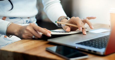 Closeup of hand asian businesswoman holding pencil and using laptop to searching data for working at home