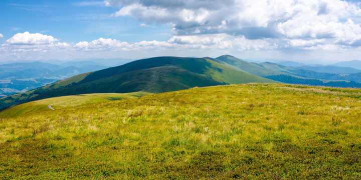 mountain ridge rolling in to the distance. wonderful sunny weather with clouds on the sky. explore carpathian mountains concept