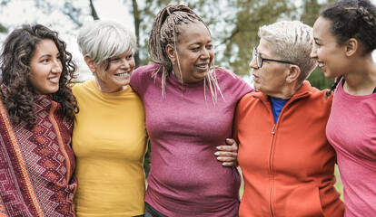 Cheerful multi generational women having fun at city park while hugging each other - Multiracial...