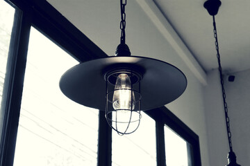 Light bulb and lamp in vintage style hanging from the ceiling.