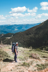 Fototapeta premium young hiker man in mountains. summer trekking path
