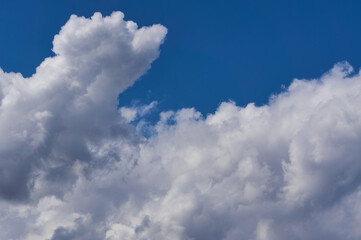 Cumulus white clouds on the blue sky